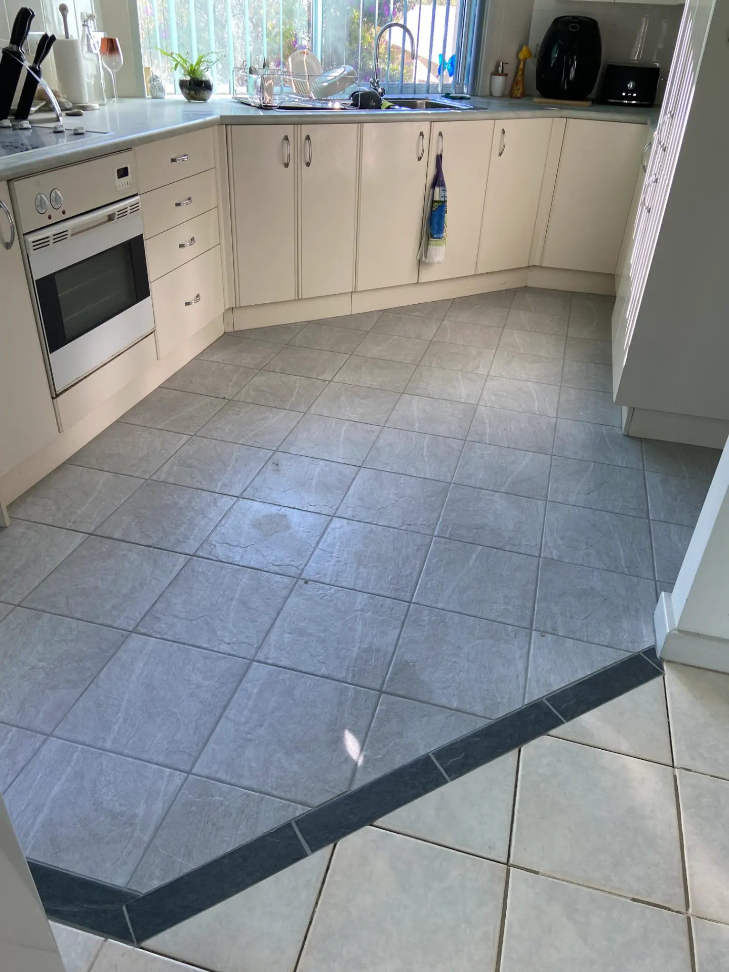 Finished kitchen splashback tiled directly over the existing surface after a tile over tile installation